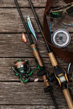 A selection of fishing tackle including various hooks, sinkers, and lures arranged neatly in a tackle box, illustrating the importance of having a well-stocked tackle box for adapting to different fishing conditions.