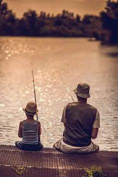 A group of anglers standing on a fishing pier extending into the ocean, with fishing rods in hand and lines in the water, showcasing the excitement and camaraderie of fishing from bustling fishing piers.